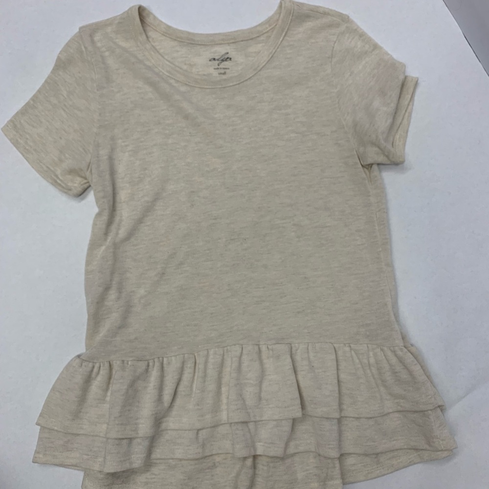 Cream color shirt, ruffles at the bottom. Super comfy! Size small